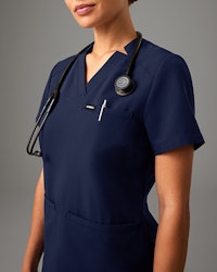 A woman wearing blue scrubs.