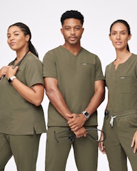 group of healthcare workers wearing matching dark olive scrubs