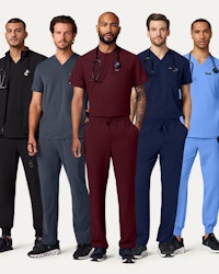 A group of men wearing scrubs.