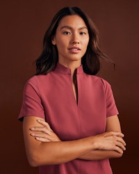 Woman wearing a collared scrub top.