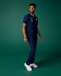 Man wearing scrubs standing