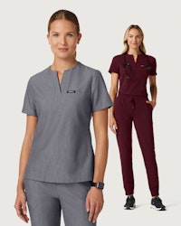 2 female HCP workers wearing gray and burgundy scrubs standing one in front of the other