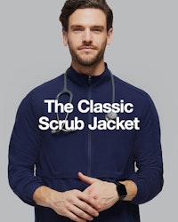 male healthcare worker wearing navy scrub jacket