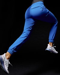 woman running in blue joggers