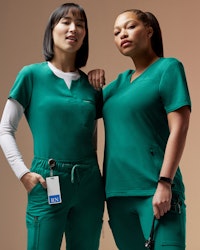 Two women in green scrubs