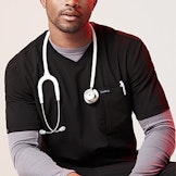 male hcp sitting and wearing stethoscope around neck