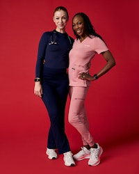 Two women wearing scrubs