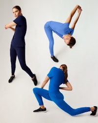 3 HCP workers stretching in blue scrubs