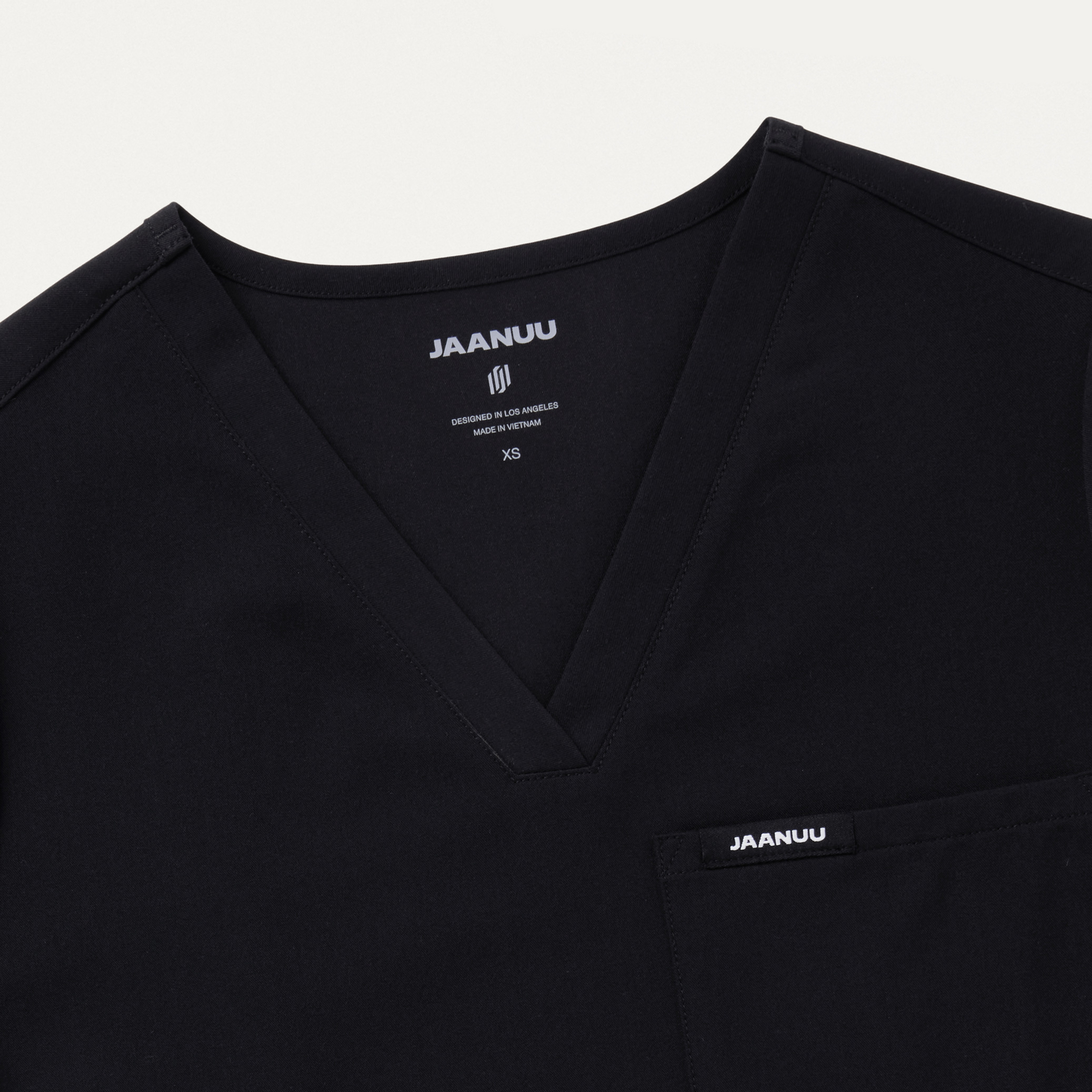 Rhena Essential 1Pocket Scrub Top in Black Women's Tops by Jaanuu